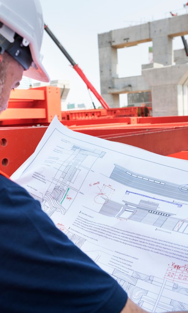 Worker studying blueprint